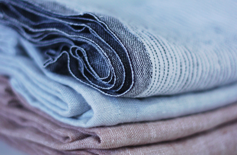 three various coloured fabrics folded in a stack